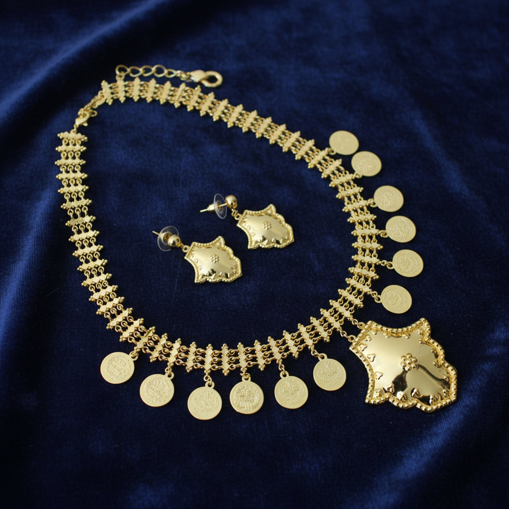 Gold necklace with coin pendants and matching earrings on a dark background