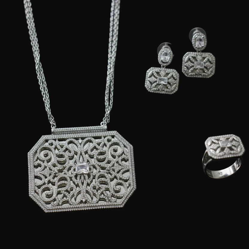 Silver jewelry set including necklace, ring, and earrings on a dark background