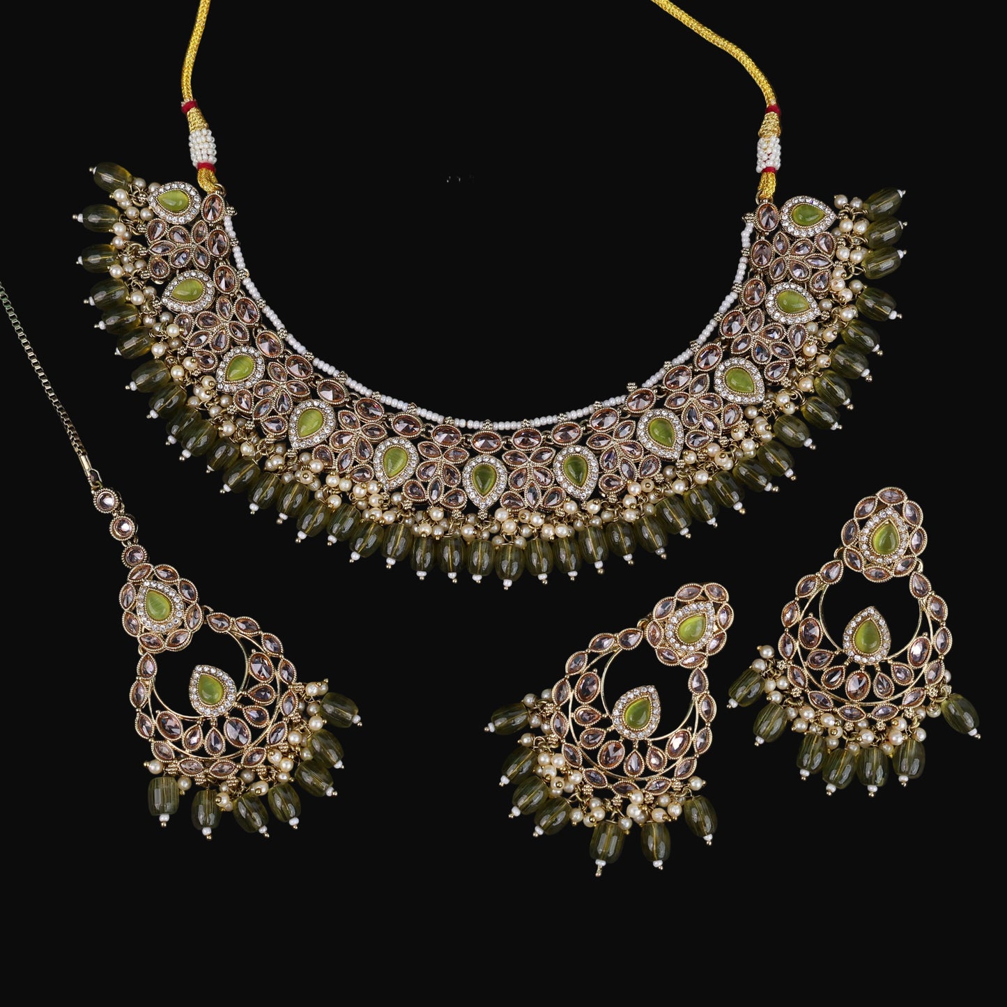 Jewelry set with necklace, earrings, and ring on a dark background with 'Saheli' branding.