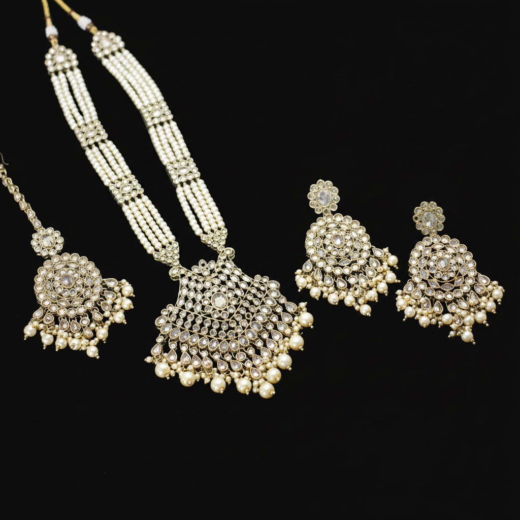 Ornate necklace and earrings set on a dark background