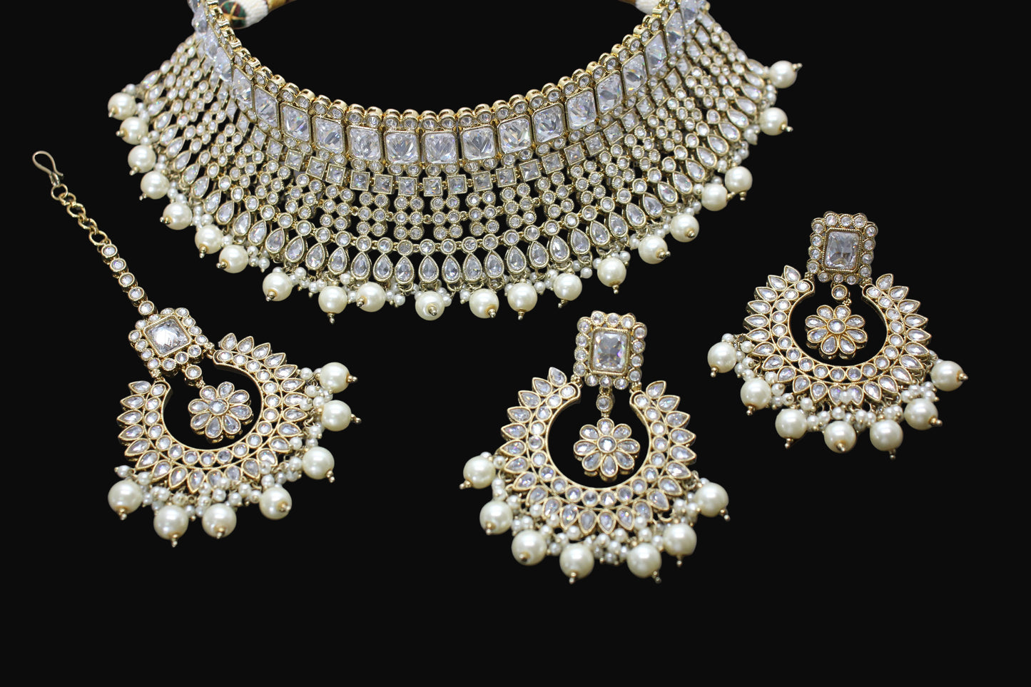 Jewelry set with necklace and earrings on a dark background