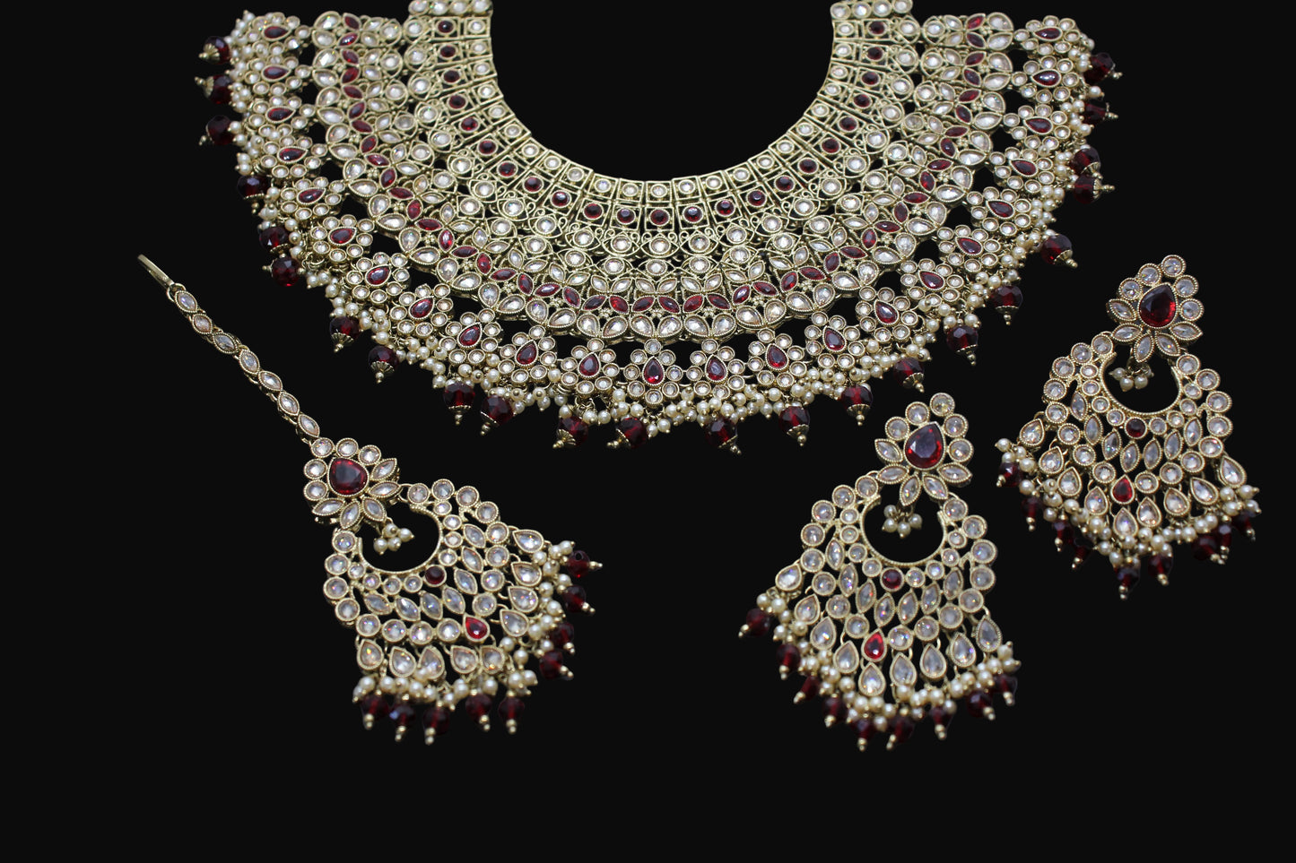 Ornate necklace set with pendants on a dark background