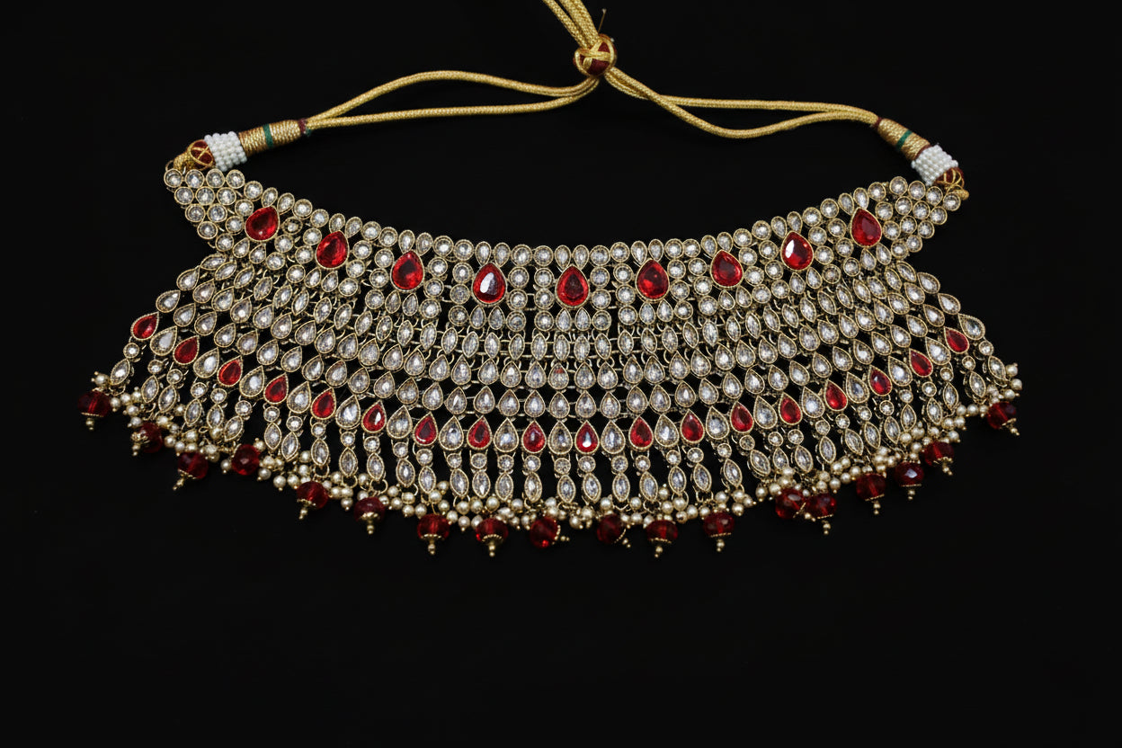 Ornate necklace with red stones on a dark background