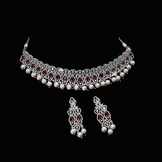 Jewelry set with necklace and earrings on a dark background, featuring the brand 'Saheli'.