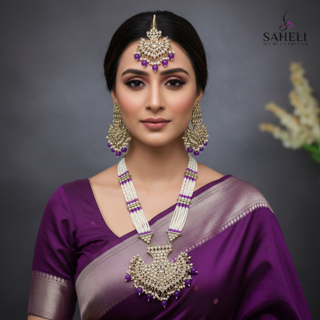 Jewelry set with necklace and earrings on a dark background, featuring the brand 'Saheli'.