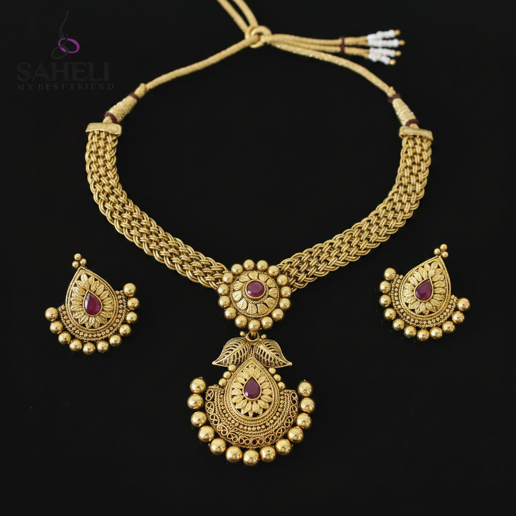 Gold necklace and earrings set with 'SAHELI' branding on a dark background