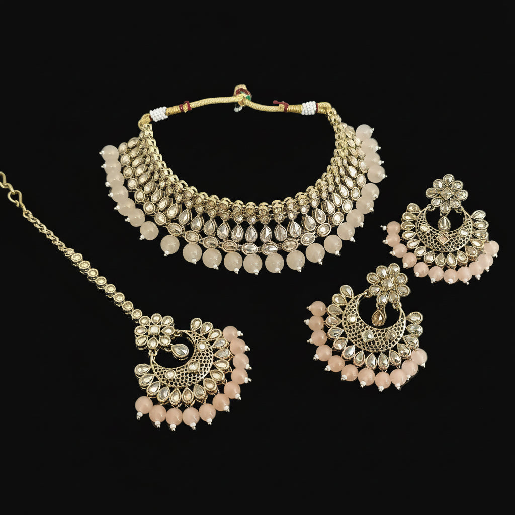 Gold and pink jewelry set on a dark background
