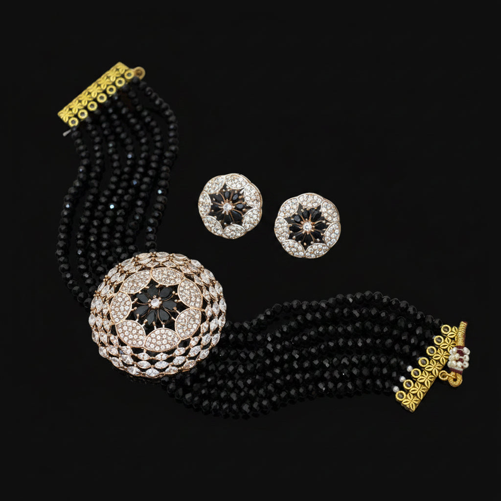 Jewelry set with black beaded necklace, earrings, and brooch on a dark background