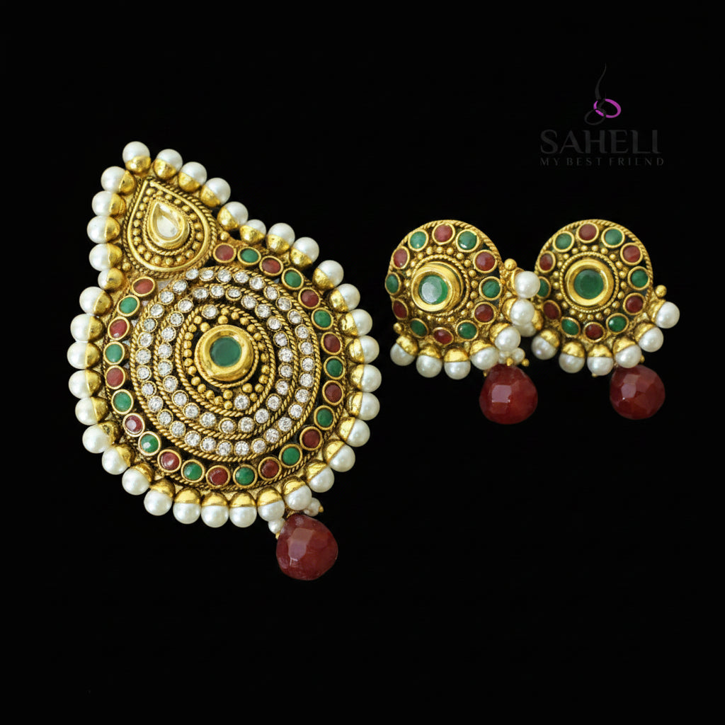 Ornate gold earrings with pearls and gemstones on a dark background, featuring the brand 'Saheli'.