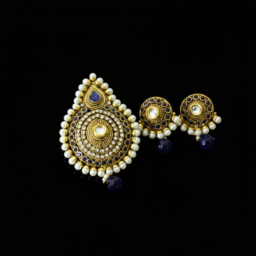 Gold and pearl earrings with blue stones on a dark background, branded 'Saheli'.