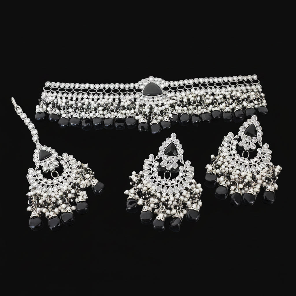 Black and silver beaded jewelry set on a dark background