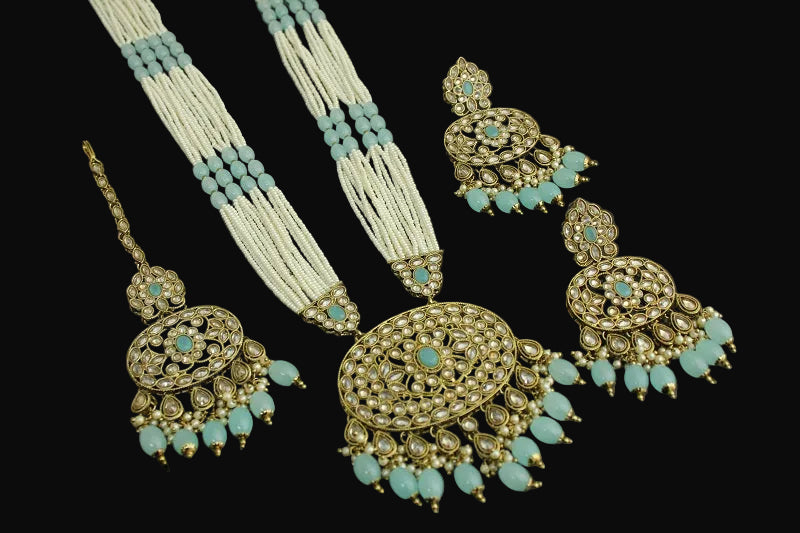 Jewelry set with necklace, earrings, and hair accessories on a dark background