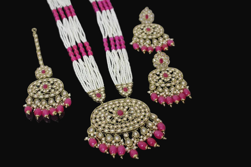 Jewelry set with necklace, earrings, and hair accessories on a dark background