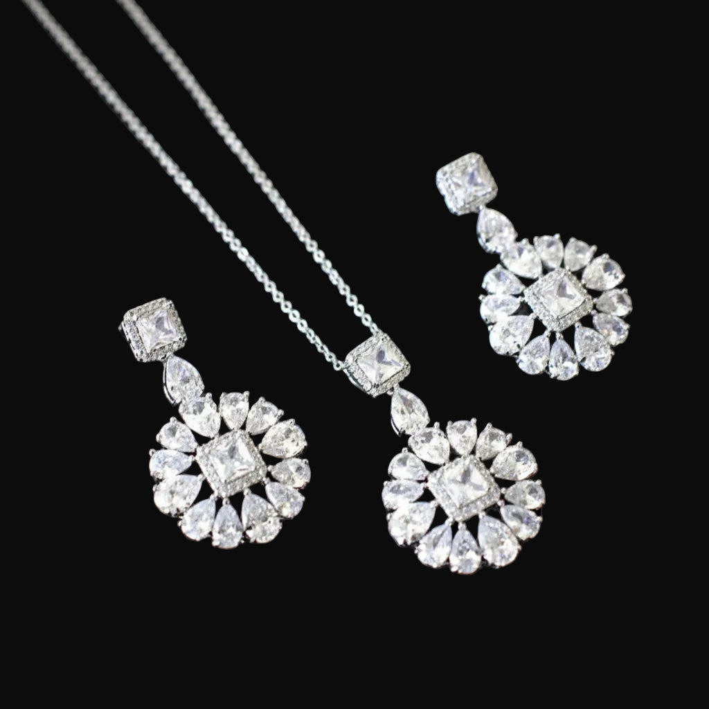 Jewelry set with necklace and earrings on a black background, featuring the brand 'Saheli'.