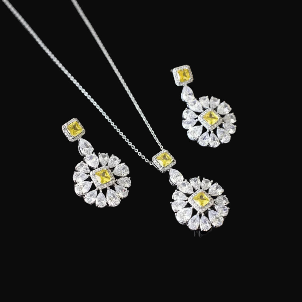 Jewelry set with necklace and earrings featuring yellow gemstones on a black background, branded 'SAHELI'.