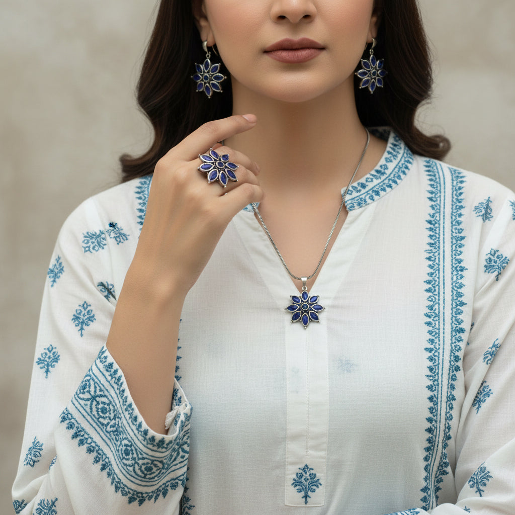 Silver jewelry set with blue stones on a dark background