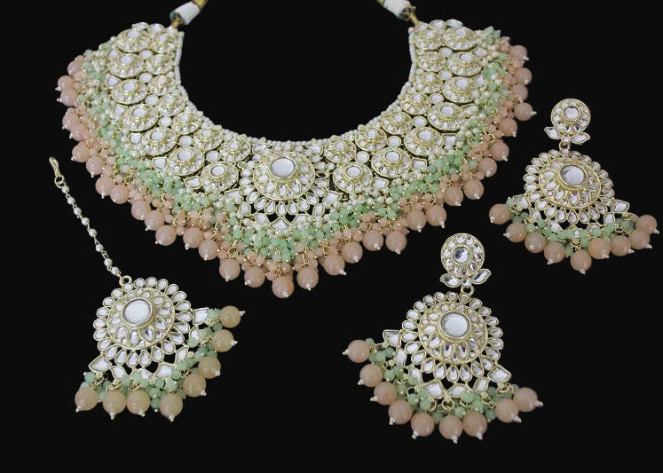 Jewelry set with necklace, earrings, and hair accessory on a dark background